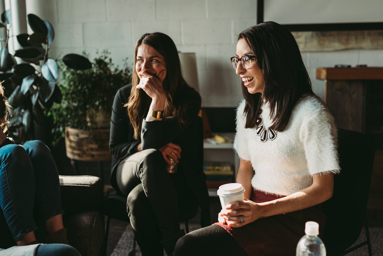 Managers sharing a light moment around the table during a HumanSide session